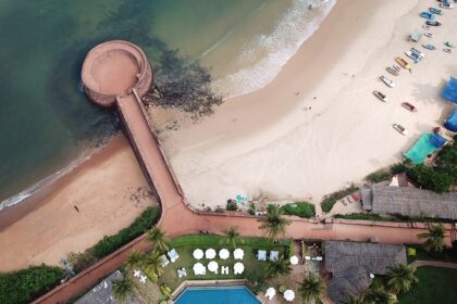 Aerial view of Aguada Fort Lower, North Goa surrounded by beach and lush greenery