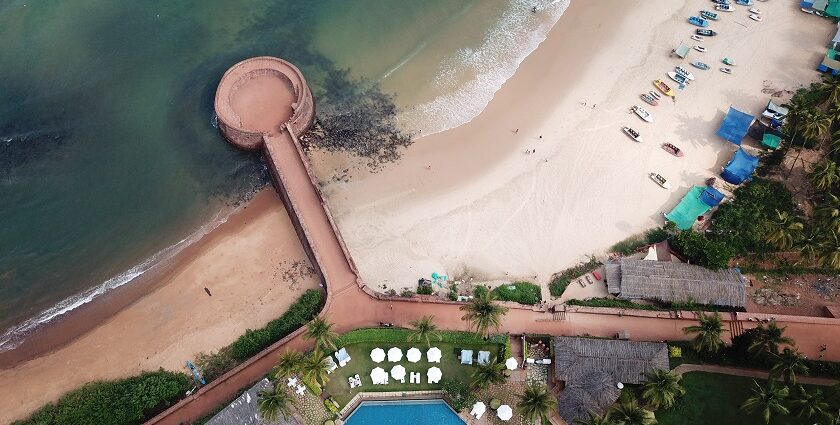 Aerial view of Aguada Fort Lower, North Goa surrounded by beach and lush greenery