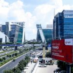 Image of Gurugram cyber city with stunning architecture and busy road during day time