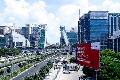 Image of Gurugram cyber city with stunning architecture and busy road during day time