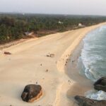 A bird’s eye view of a beach in Karnataka featuring pristine sands and azure waters.