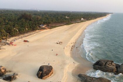 A bird’s eye view of a beach in Karnataka featuring pristine sands and azure waters.