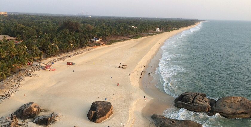 A bird’s eye view of a beach in Karnataka featuring pristine sands and azure waters.