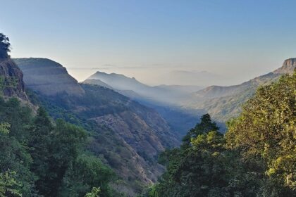 An image of Matheran during summer, showcasing lush greenery and hills in the day.