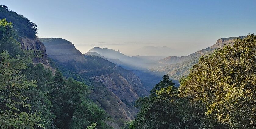 An image of Matheran during summer, showcasing lush greenery and hills in the day.