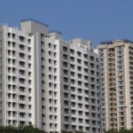 A picture of Mira Road featuring modern buildings and clear blue skies.