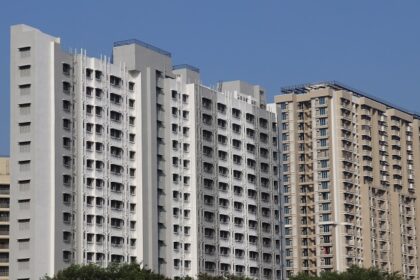 A picture of Mira Road featuring modern buildings and clear blue skies.