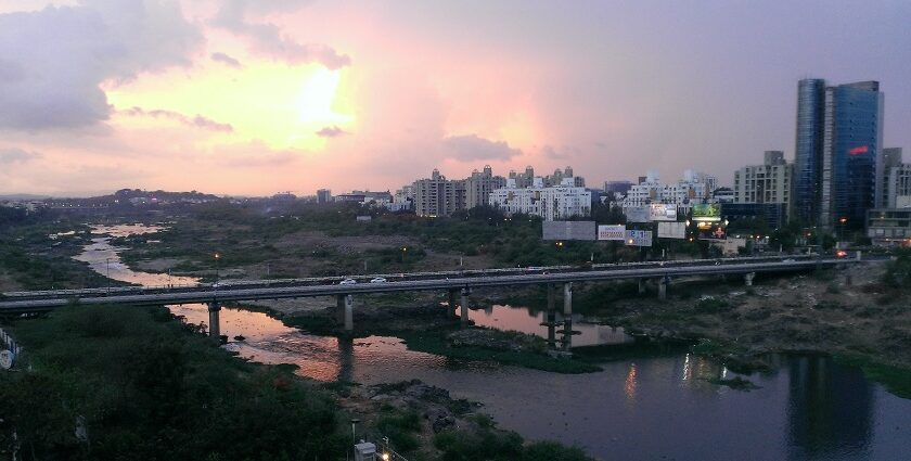 A panoramic view of Pune's scenic landscape, featuring lush greenery, sea, and buildings.