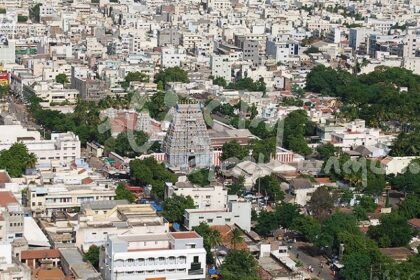 A picture capturing the aerial view of Karur featuring many white houses and trees.