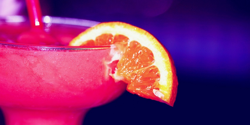 Pink Berry frozen smoothie garnished with a slice of orange served in a fancy glass is one of the best foods in Lonavala.