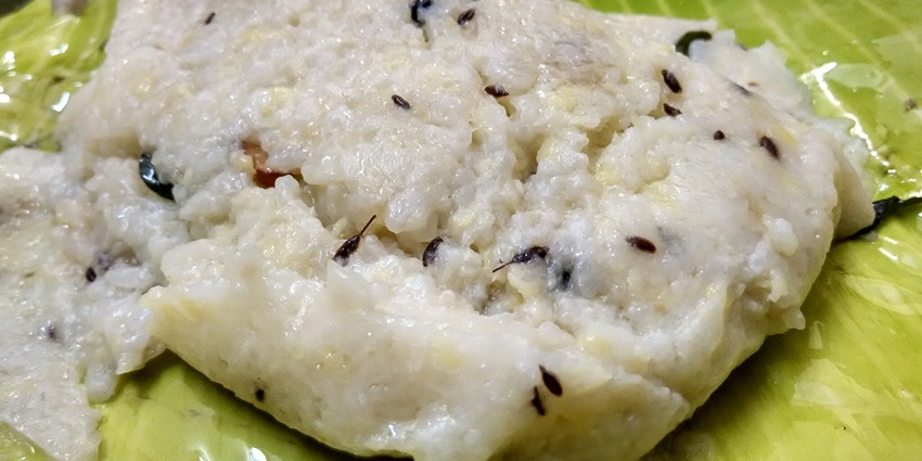 Image of Ven Pongal served on banana leaf - Traditional Tamil dish made with rice and lentils, savoury