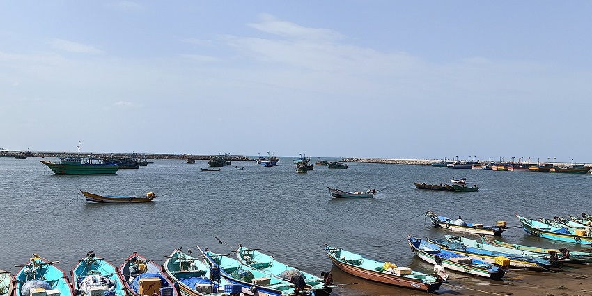 A picture of a Poompuhar beach ideal for a laid-back outing and some boats.
