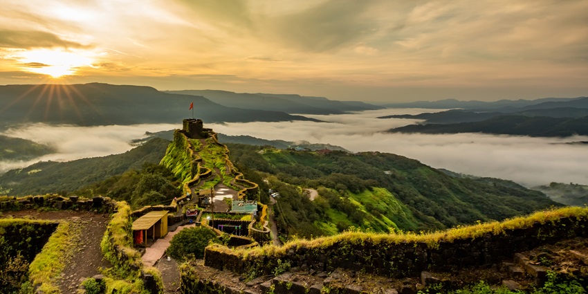 A view of Pratapgad Fort perched on a hill, a popular destination near Gandharpale caves.