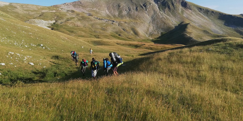 View of tourists trekking the lush verdant landscapes of this trek