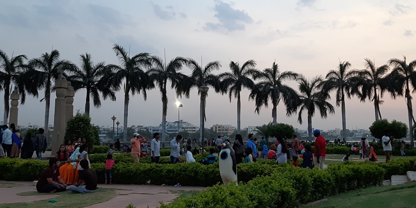 A breathtaking evening view of Priyadarshini Park with a lot of people roaming.