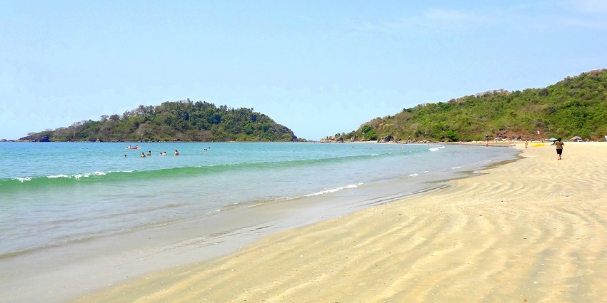 A picture of a beach with Palm trees that is great for a stop between road trips from Pune.