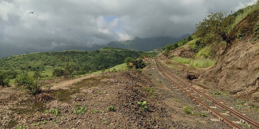 A picture of green hills and foggy paths on a road trip from Pune to Matheran.