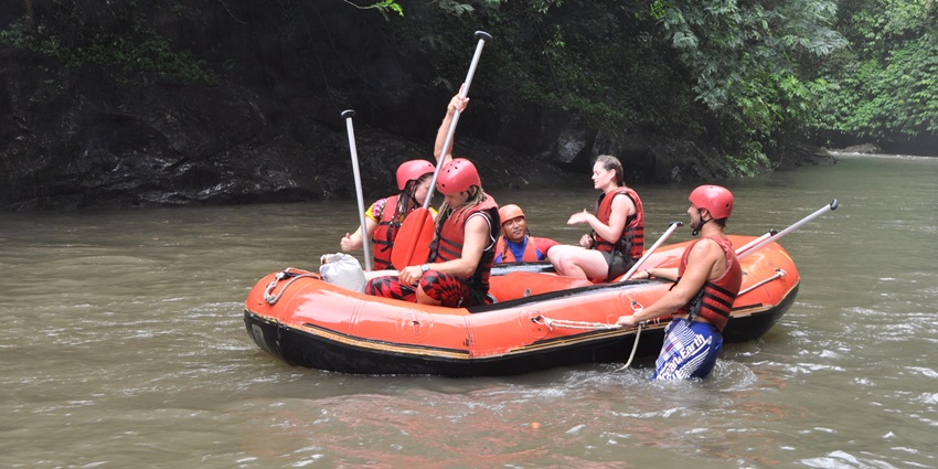 A picture of a group of tourists enjoying rafting in the steady stream of Ayung River, Ubud