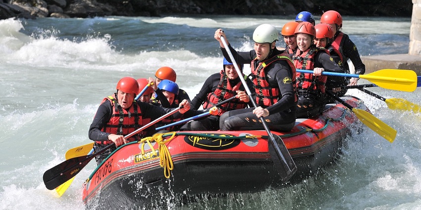 A picture of a group of rafters navigating through the rapids of the Bhatsa River.