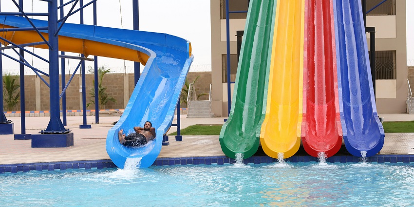 A view of children enjoying the wave pool in a lively atmosphere at the Raja Bhoj Water Park