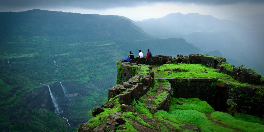 A view of Rajmachi Fort surrounded by green hills, a popular tourist attraction near Pune