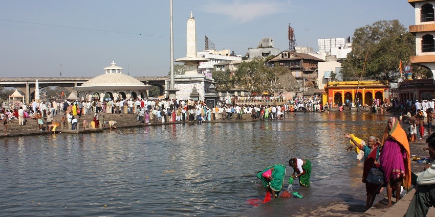 Devotees take a sacred bath in the Ramkund on the Godavari River in Nashik, Maharashtra.