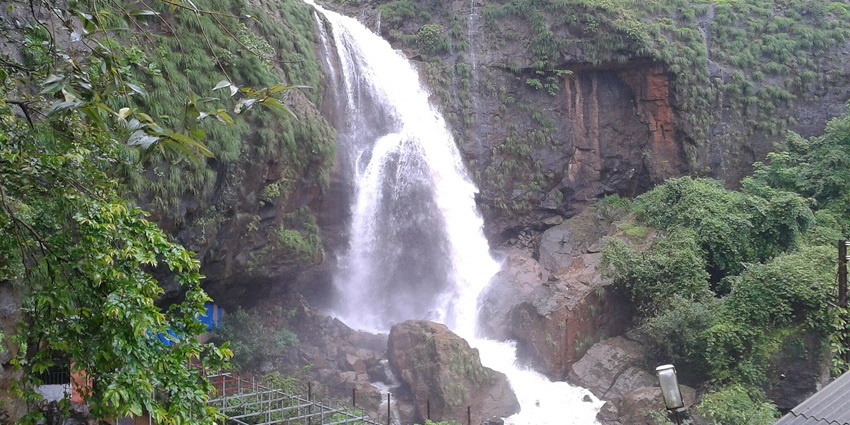 Stunning view of Waterfalls cascading amidst lush greenery and rocks