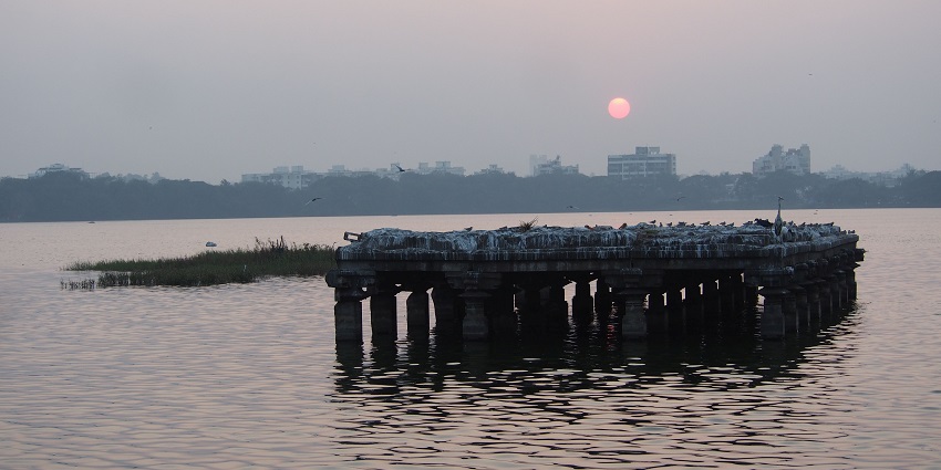 Scenic view of the Rankala lake with the sun setting at the horizon