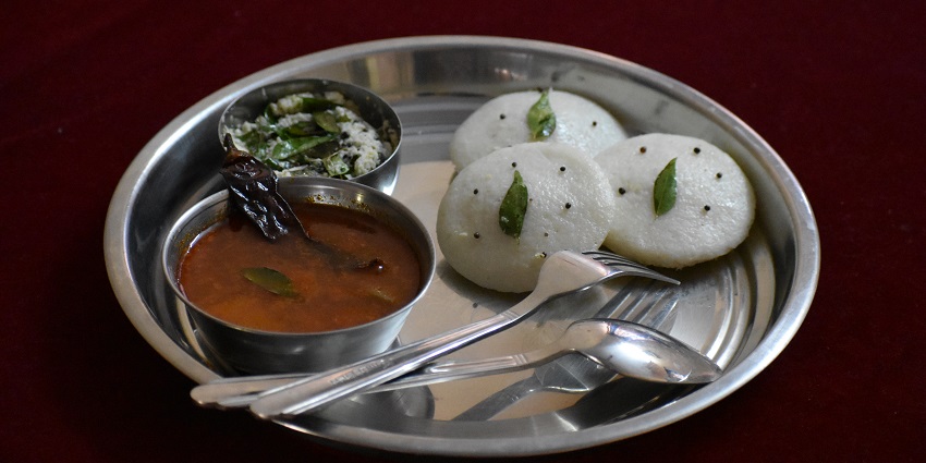 mage of Idli and sambar served on a plate - Iconic eatery is known for its flavorful sambar and idlis