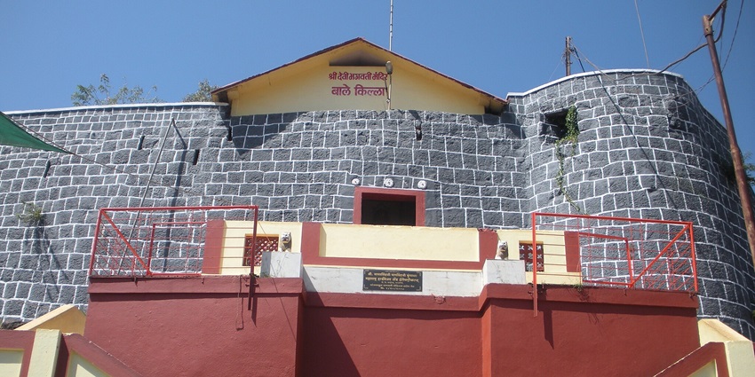 Entrance to Ratnadurg Fort, showcasing stone walls, a tourist attraction near Dategad Fort