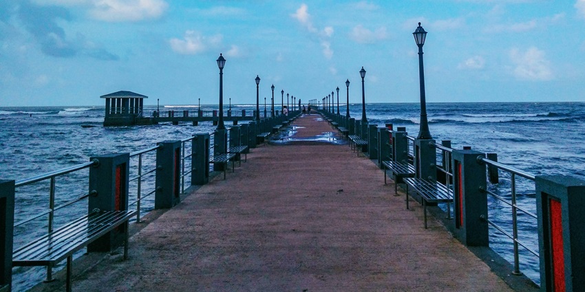 A panoramic view of a dockyard surrounded by shimmering waters in Ratnagiri, Maharashtra.