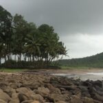 Serene beach view with golden sands and azure waters, a highlight of Ratnagiri Beaches.