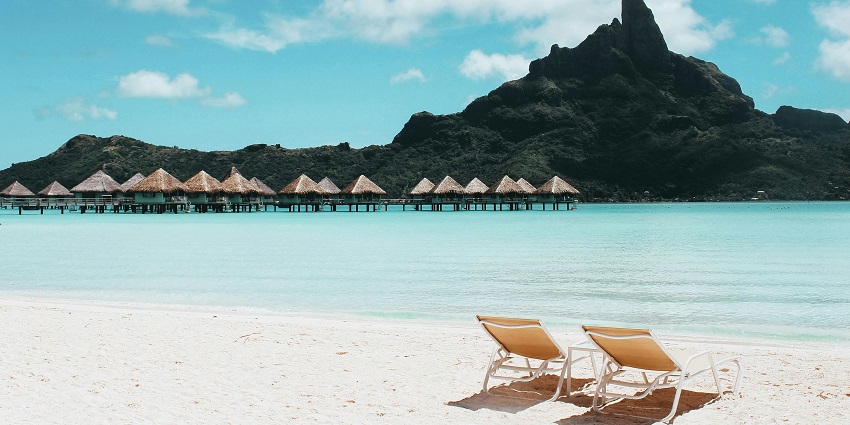 An image of beachgoers lounging on soft sands, sunbathing at Pandawa Beach.