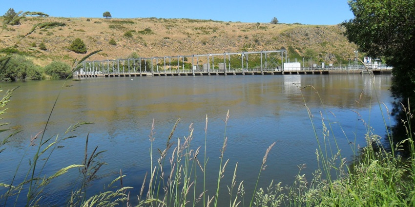 An image with distant view of a River Dam with river and hills, similar to Asna river dam