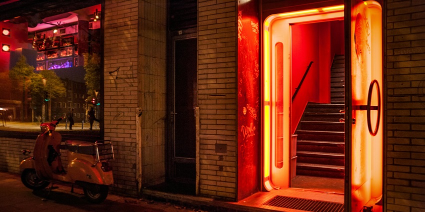 A picture of the entrance of a night bar in Nagpur, with a scooter parked against the wall