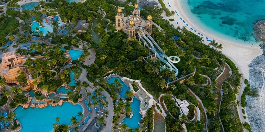 Aerial view of a vibrant water theme park featuring colorful slides and pools.