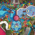 An aerial view of a Royal Water Park with colourful pools and slides in Vasai, Mumbai.