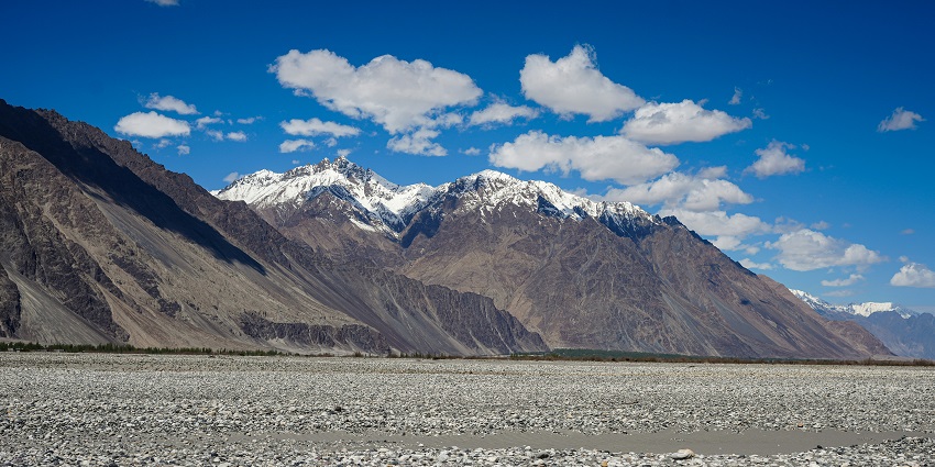 An astonishing vista of Saboo to Khalsar featuring towering snow-clad mountains.