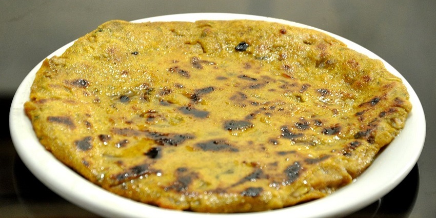 Thali Peeth, a Maharashtrian delicacy served on a plate topped with clarified butter.