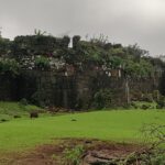 Stone walls of Sagargad Fort with a panoramic view of the surrounding landscape.