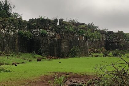 Stone walls of Sagargad Fort with a panoramic view of the surrounding landscape.