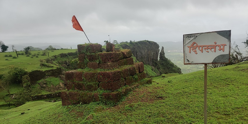 Deepa Sthambh at Sagargad Fort, surrounded by lush greenery and a clear sky, ideal for visitors during the best times to explore.