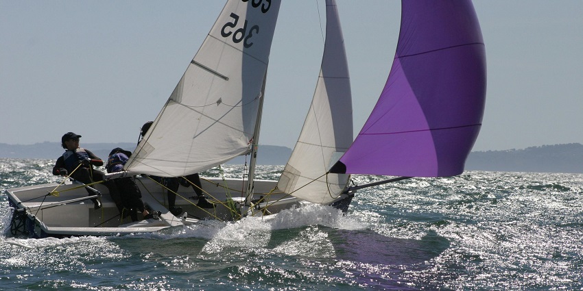 Person in Blue and White Sailboat on Body of Water during Daytime - water sports in Mumbai beaches