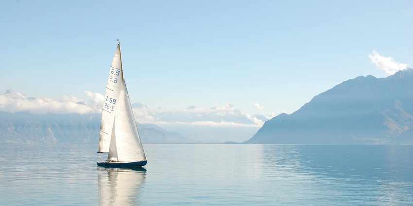 An image of a sailboat gliding smoothly across the calm waters of Pawna Lake.