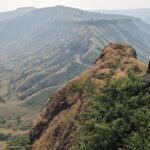 Majestic view of Sajjangad Fort nestled in the Sahyadri mountains.