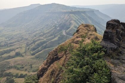 Majestic view of Sajjangad Fort nestled in the Sahyadri mountains.