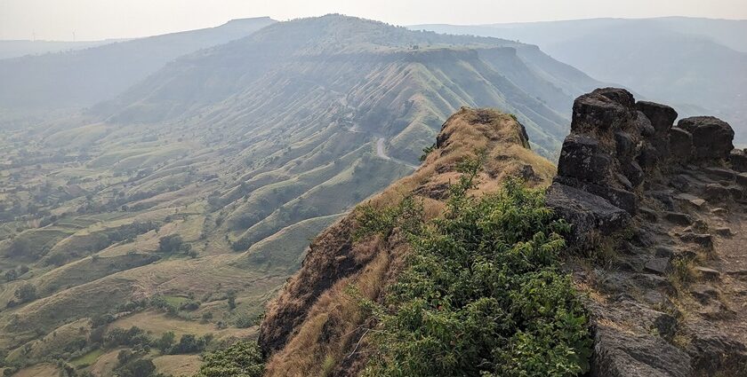 Majestic view of Sajjangad Fort nestled in the Sahyadri mountains.