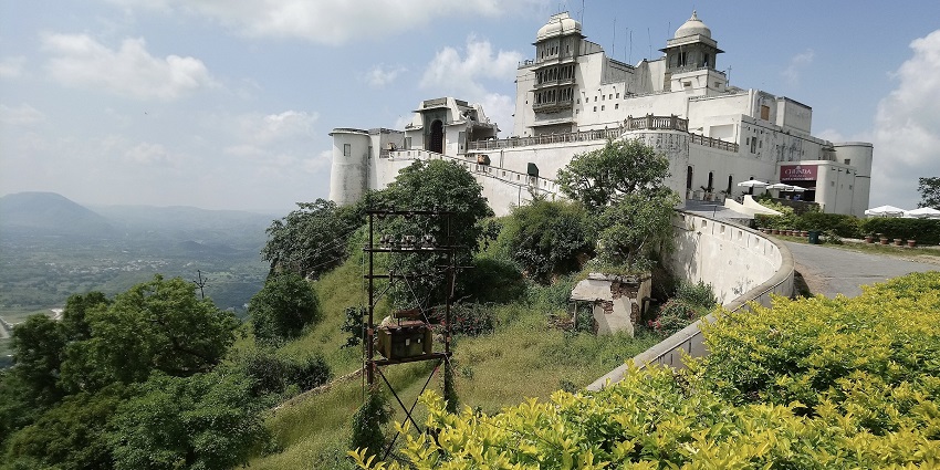 Monsoon palace from a distance on the Bansdara hill in Udaipur, surrounded by trees