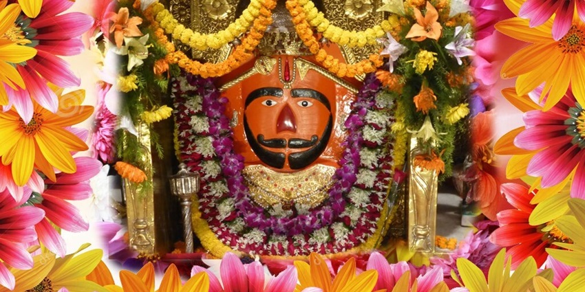 Idol of Lord Balaji with flowers around in devotion and respect attracting several pilgrims