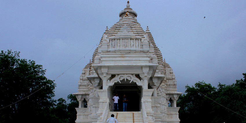 White temple with carved spire dedicated to Goddess Saraswati at Pilani, Rajasthan.